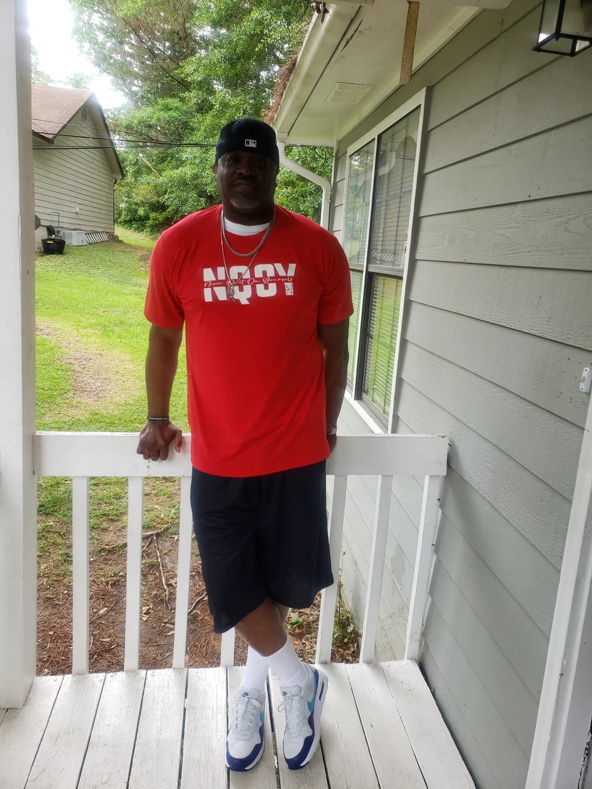 Red tee on the front porch